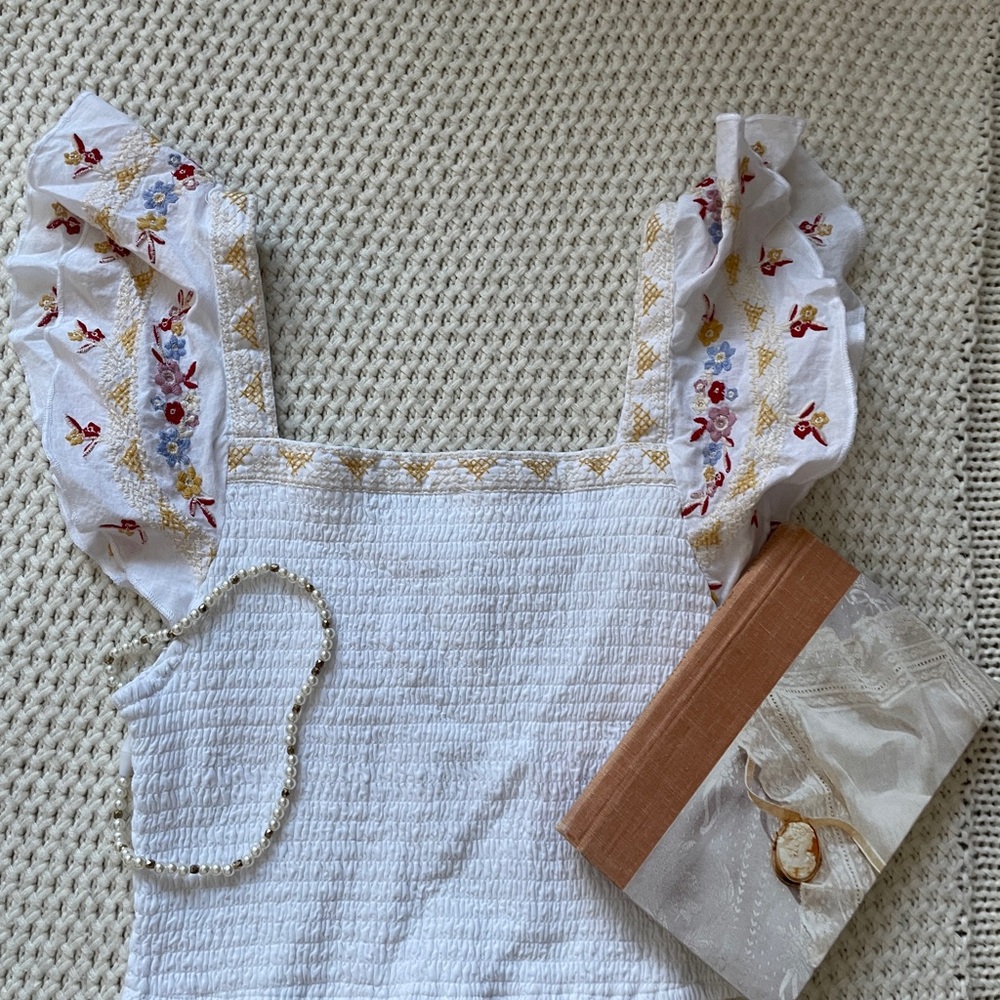 White cropped blouse with embroidered sleeves and top